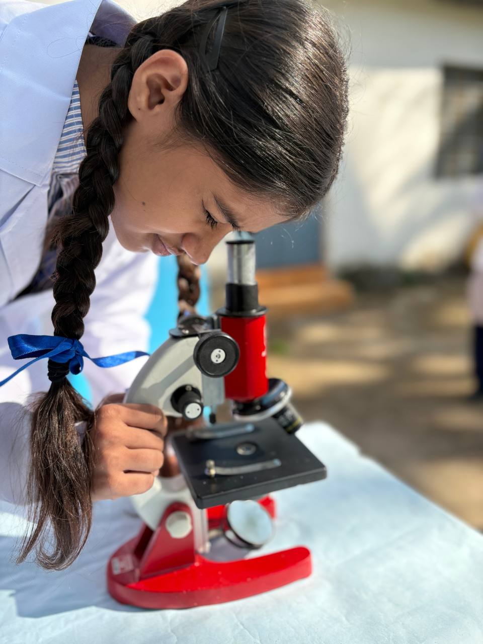 Student looking through microscope at science fair